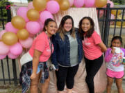 ROSE VILLAGE: Ashley Jones, center, poses for a photo with Boys & Girls Clubs Washington Elementary Club employees Mikaela Bolds, left, and Maria Ramirez, right, and club member Rolynda, far right.