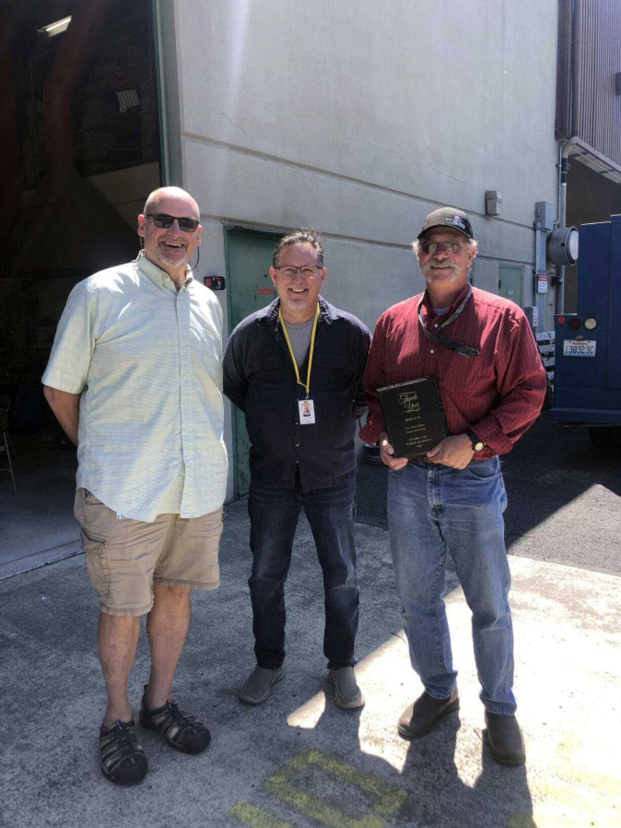 WOODLAND: Superintendent Michael Green, from left, and KWRL Director Shannon Barnett celebrate with Bob Lute, who retired this year after 42 years of service.