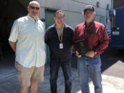 WOODLAND: Superintendent Michael Green, from left, and KWRL Director Shannon Barnett celebrate with Bob Lute, who retired this year after 42 years of service.