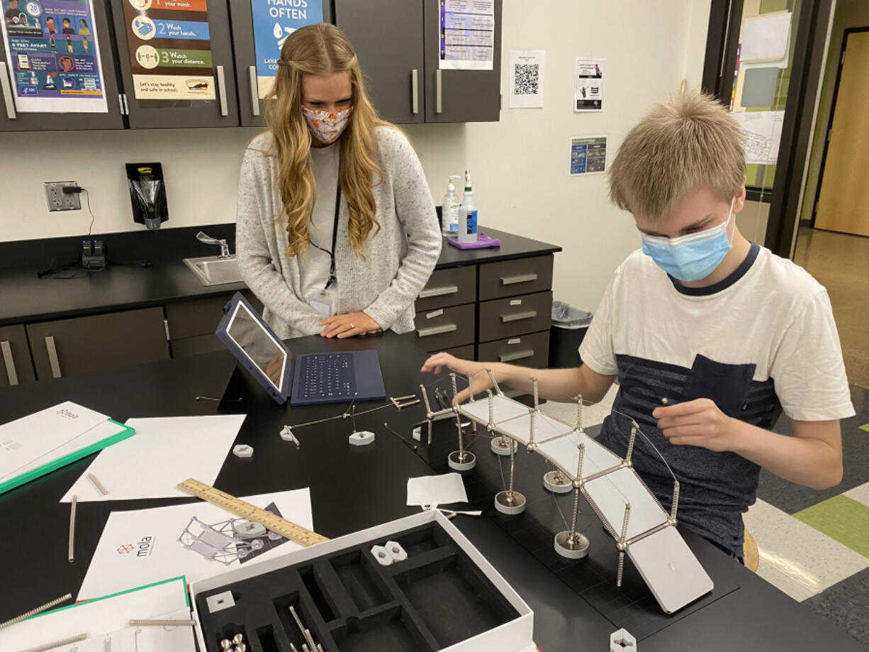 WASHOUGAL: Sydney Loveland, math and science teacher, works with student Brycen Murray on a walking bridge concept.