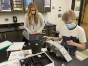 WASHOUGAL: Sydney Loveland, math and science teacher, works with student Brycen Murray on a walking bridge concept.