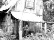 Author Stephen Altschuler in 1977, age 32, and his home in the New Hampshire woods.