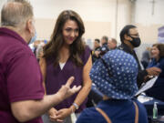 Henry Pio of Hazel Dell, from left, talks with Congresswoman Jaime Herrera Beutler as she greets his stepdaughter, Geovanna Alarcon, who is looking for employment, during a job fair at the Clark County Event Center in August.