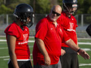 Fort Vancouver second-year coach Doug Bilodeau walks his offensive line through a trapping block scheme as high school football started its first fall season since 2019 on Wednesday, Aug. 18, 2021, at Fort Vancouver High School.
