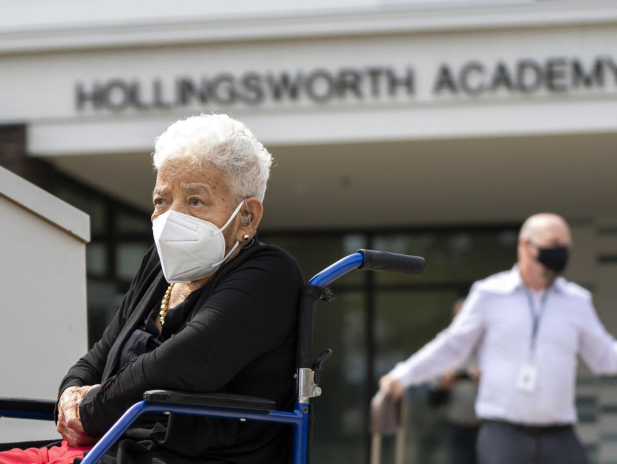 Dorothy Hollingsworth sits next to a podium Thursday prior to the ribbon-cutting ceremony at Hollingsworth Academy. The school, formerly 49th Street Academy, was named after Hollingsworth in honor of her achievements in education, including being the first Black woman to serve on Seattle's school board. Hollingsworth is 100 years old and came with her family from Seattle for Thursday's ceremony.