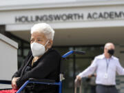 Dorothy Hollingsworth sits next to a podium Thursday prior to the ribbon-cutting ceremony at Hollingsworth Academy. The school, formerly 49th Street Academy, was named after Hollingsworth in honor of her achievements in education, including being the first Black woman to serve on Seattle's school board. Hollingsworth is 100 years old and came with her family from Seattle for Thursday's ceremony.