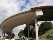 An American flag blows in the wind on the Pioneer Street rail overpass on Tuesday in Ridgefield. The nearly finished overpass connects downtown with the boat launch area to the west of the railway.