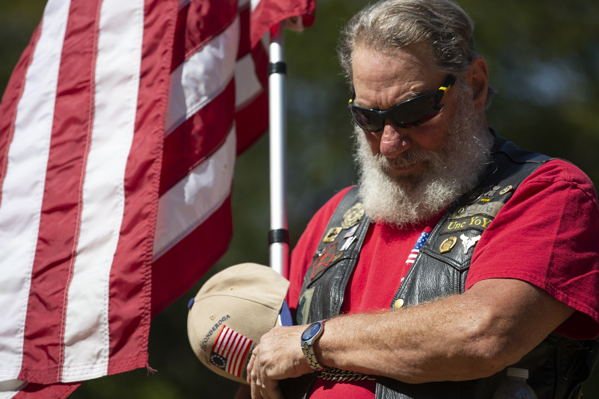 Patriot Guard Rider, Joe Fettig, also known as Unc YoYo, holds an American flag during a ceremony honoring the memory of U.S. Army Sgt. Earl D. Warner and U.S. Army Sgt. Bryce D. Howard at Fort Vancouver Barracks War Memorial in Vancouver on Saturday, August 28, 2021.