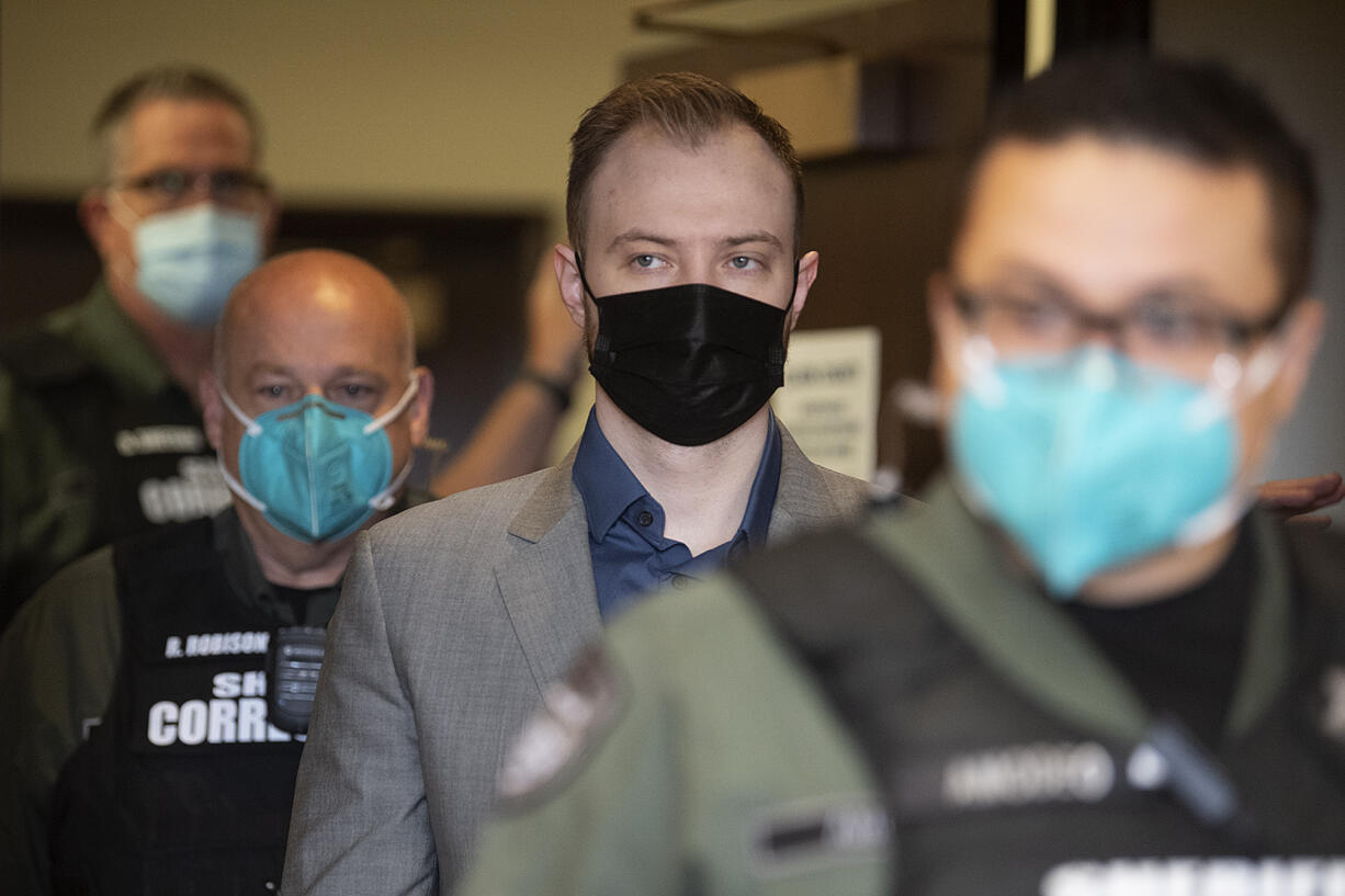 David Bogdanov is escorted into the courtroom on Friday before the verdict is read in the slaying of Nikki Kuhnhausen.