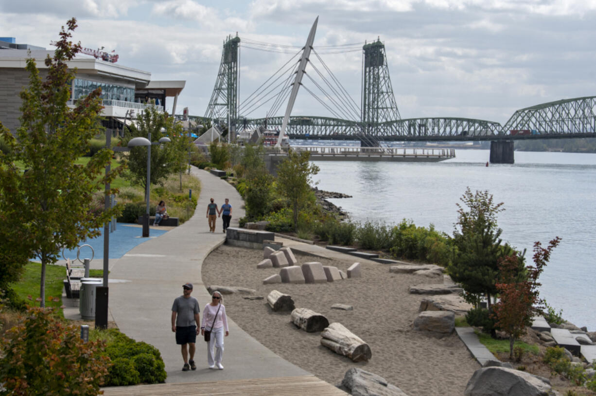 Pedestrians take in sweeping views of the Columbia River while strolling along the Waterfront Vancouver on Monday morning. Below, Rayne Dunn, 12, of Vancouver, left, joins Layla Chappell, also 12, as they celebrate her birthday with a fancy dress and a visit to the Waterfront Vancouver on Monday morning.