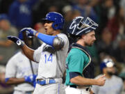 Kansas City Royals' Edward Olivares (14) celebrates his two-run home run as Seattle Mariners catcher Tom Murphy looks away in the 12th inning of a baseball game Friday, Aug. 27, 2021, in Seattle.