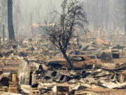 Homes and cars destroyed by the Dixie Fire line central Greenville on Thursday, Aug. 5, 2021, in Plumas County, Calif.