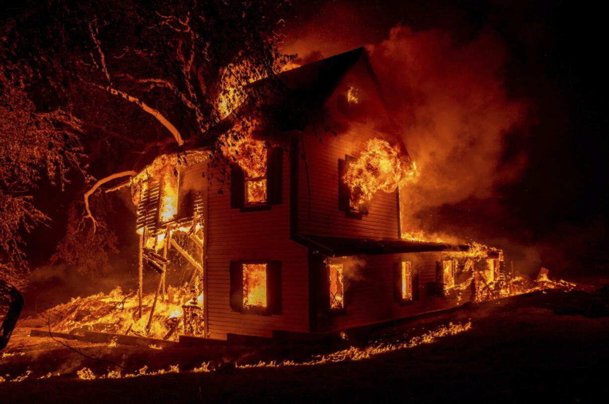 A home burns on Jeters Road as the Dixie fire jumps Highway 395 south of Janesville, Calif., on Monday, Aug. 16, 2021. Critical fire weather throughout the region threatens to spread multiple wildfires burning in Northern California.