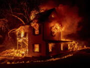 A home burns on Jeters Road as the Dixie fire jumps Highway 395 south of Janesville, Calif., on Monday, Aug. 16, 2021. Critical fire weather throughout the region threatens to spread multiple wildfires burning in Northern California.