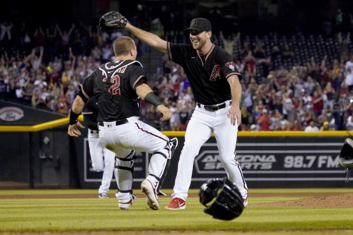 Arizona Diamondbacks starting pitcher Tyler Gilbert, right, celebrates after his complete game no hitter against the San Diego Padres with catcher Daulton Varsho, Saturday, Aug. 14, 2021, in Phoenix. It was Gilbert's first career start. The Diamondbacks won 7-0.