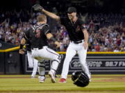 Arizona Diamondbacks starting pitcher Tyler Gilbert, right, celebrates after his complete game no hitter against the San Diego Padres with catcher Daulton Varsho, Saturday, Aug. 14, 2021, in Phoenix. It was Gilbert's first career start. The Diamondbacks won 7-0.