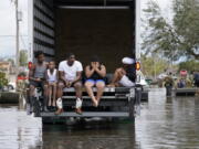 People are evacuated from floodwaters in the aftermath of Hurricane Ida in LaPlace, La., Monday, Aug. 30, 2021.