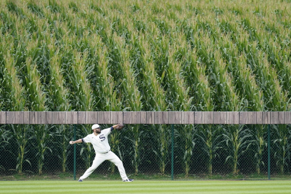 Chicago White Sox pitcher Lance Lynn warms up in the outfield before a baseball game against the New York Yankees, Thursday, Aug. 12, 2021 in Dyersville, Iowa. The Yankees and White Sox are playing at a temporary stadium in the middle of a cornfield at the Field of Dreams movie site, the first Major League Baseball game held in Iowa.