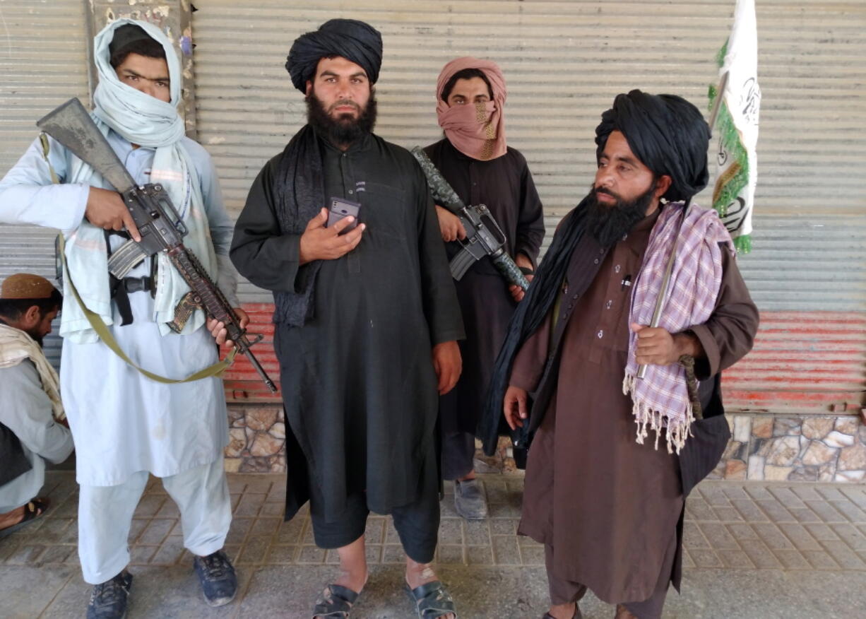 Taliban fighters patrol Wednesday inside the city of Farah, the capital of Farah province, Afghanistan.