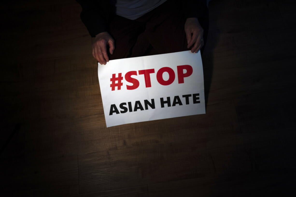 Jen Ho Lee, a 76-year-old South Korean immigrant, displays a sign March 31 from a rally against anti-Asian hate crimes she attended in Los Angeles.