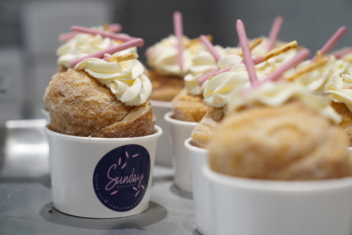 Strawberry Pocky Cruffins are displayed on a tray at the Sunday Bakeshop in Oakland, Calif., Thursday, Aug. 19, 2021. From ube cakes to mochi muffins, bakeries that sweetly encapsulate what it is to grow up Asian and American have been popping up more in recent years. Their confections are a delectable vehicle for young and intrepid Asian Americans to celebrate their dual identity.