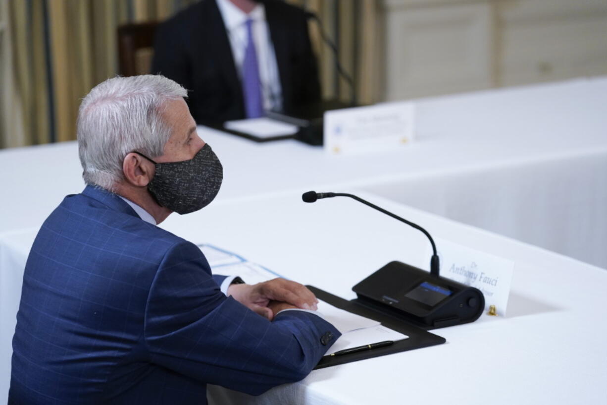 Dr. Anthony Fauci, director of the National Institute of Allergy and Infectious Diseases, listens as President Joe Biden receives a briefing in the State Dining Room of the White House in Washington, Tuesday, Aug. 10, 2021, on how the COVID-19 pandemic is impacting hurricane preparedness.