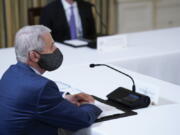 Dr. Anthony Fauci, director of the National Institute of Allergy and Infectious Diseases, listens as President Joe Biden receives a briefing in the State Dining Room of the White House in Washington, Tuesday, Aug. 10, 2021, on how the COVID-19 pandemic is impacting hurricane preparedness.