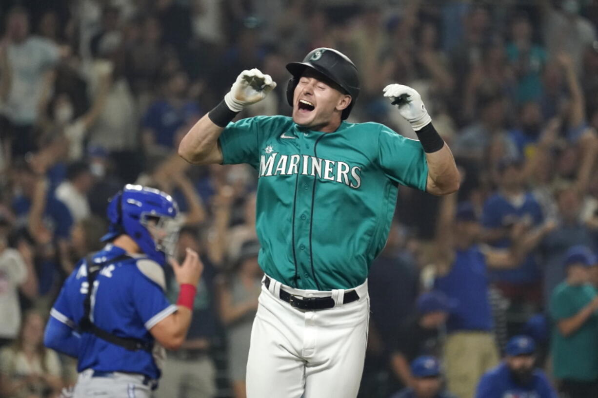 Seattle Mariners' Jarred Kelenic reacts to drawing a bases-loaded walk in the ninth inning to drive in the winning run in a baseball game against the Toronto Blue Jays on Friday, Aug. 13, 2021, in Seattle. The Mariners won 3-2.