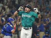 Seattle Mariners' Jarred Kelenic reacts to drawing a bases-loaded walk in the ninth inning to drive in the winning run in a baseball game against the Toronto Blue Jays on Friday, Aug. 13, 2021, in Seattle. The Mariners won 3-2.