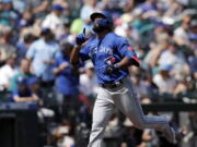 Toronto Blue Jays' Teoscar Hernandez points skyward after hitting a solo home run off a pitch by Seattle Mariners starter Logan Gilbert in the second inning on Sunday.