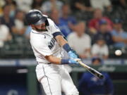 Seattle Mariners' Luis Torrens doubles in a pair of runs against the Toronto Blue Jays during the eighth inning of a baseball game Saturday, Aug. 14, 2021, in Seattle.