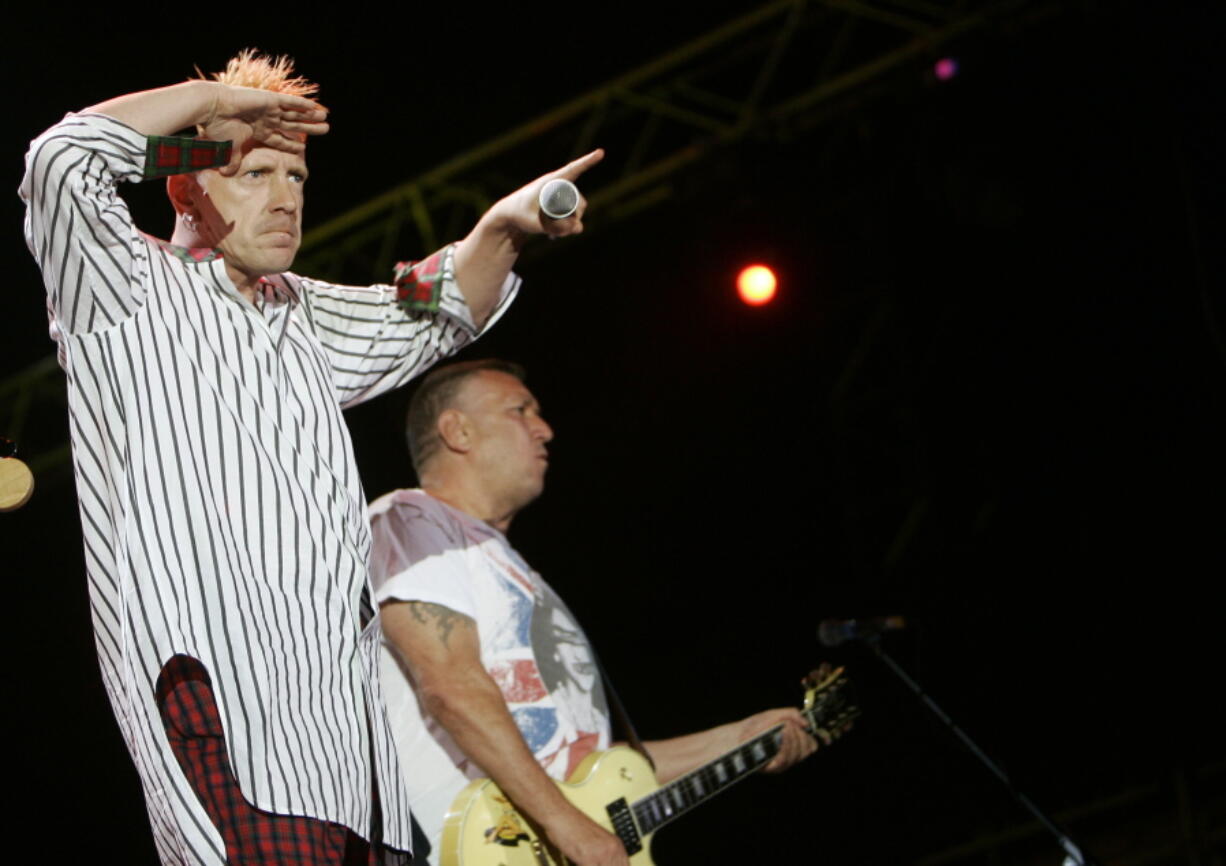 FILE - In this file photo dated Monday, July 14, 2008, John Lydon, left, and Steve Jones of British punk band the Sex Pistols perform during the Exit music festival in Novi Sad, Serbia.  A British judge has backed Sex Pistols guitarist Steve Jones and drummer Paul Cook, ruling Monday Aug.