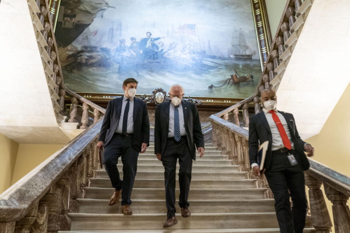 Senate Budget Committee Chairman Bernie Sanders, I-Vt., center, walks towards the Senate floor as the Senate moves from passage of the infrastructure bill to focus on a massive $3.5 trillion budget resolution, a blueprint of President Joe Biden's top domestic policy ambitions, at the Capitol in Washington, Tuesday, Aug. 10, 2021.