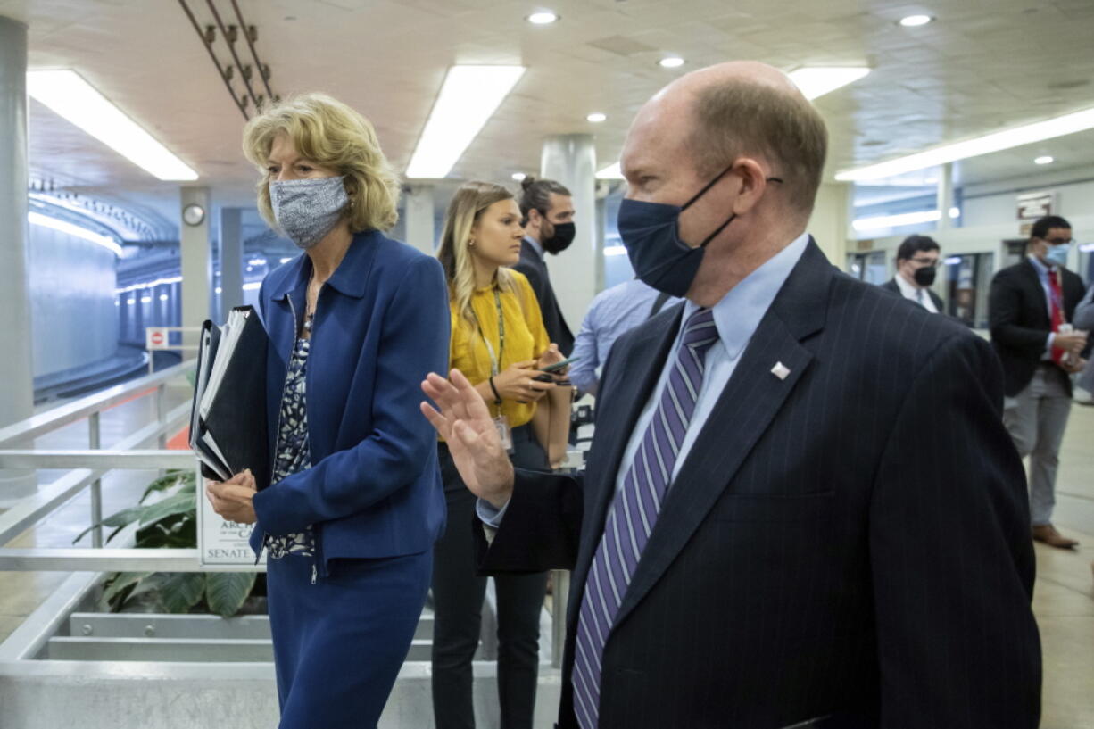 Sen. Lisa Murkowski, R-Alaska, speaks to Sen. Chris Coons, D-Del., amid continuing talks around the $1 trillion bipartisan infrastructure bill on Capitol Hill in Washington, Tuesday, Aug. 3, 2021.