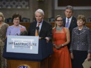 The bipartisan group of Senate negotiators speak to reporters just after a vote to start work on a nearly $1 trillion bipartisan infrastructure package, at the Capitol in Washington, Wednesday, July 28, 2021. From left are Sen. Lisa Murkowski, R-Alaska, Sen. Susan Collins, R-Maine, Sen. Rob Portman, R-Ohio, Sen. Kyrsten Sinema, D-Ariz., Sen. Joe Manchin, D-W.Va., and Sen. Jeanne Shaheen, D-N.H., (AP Photo/J.