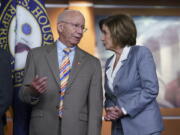 House Transportation and Infrastructure Committee Chair Peter DeFazio, D-Ore., left, talks to Speaker of the House Nancy Pelosi, D-Calif., during a news conference to discuss the "INVEST in America Act," a five-year surface transportation bill, which directs federal investments in roads, bridges, transit, and rail, at the Capitol in Washington, Wednesday, June 30, 2021. (AP Photo/J.