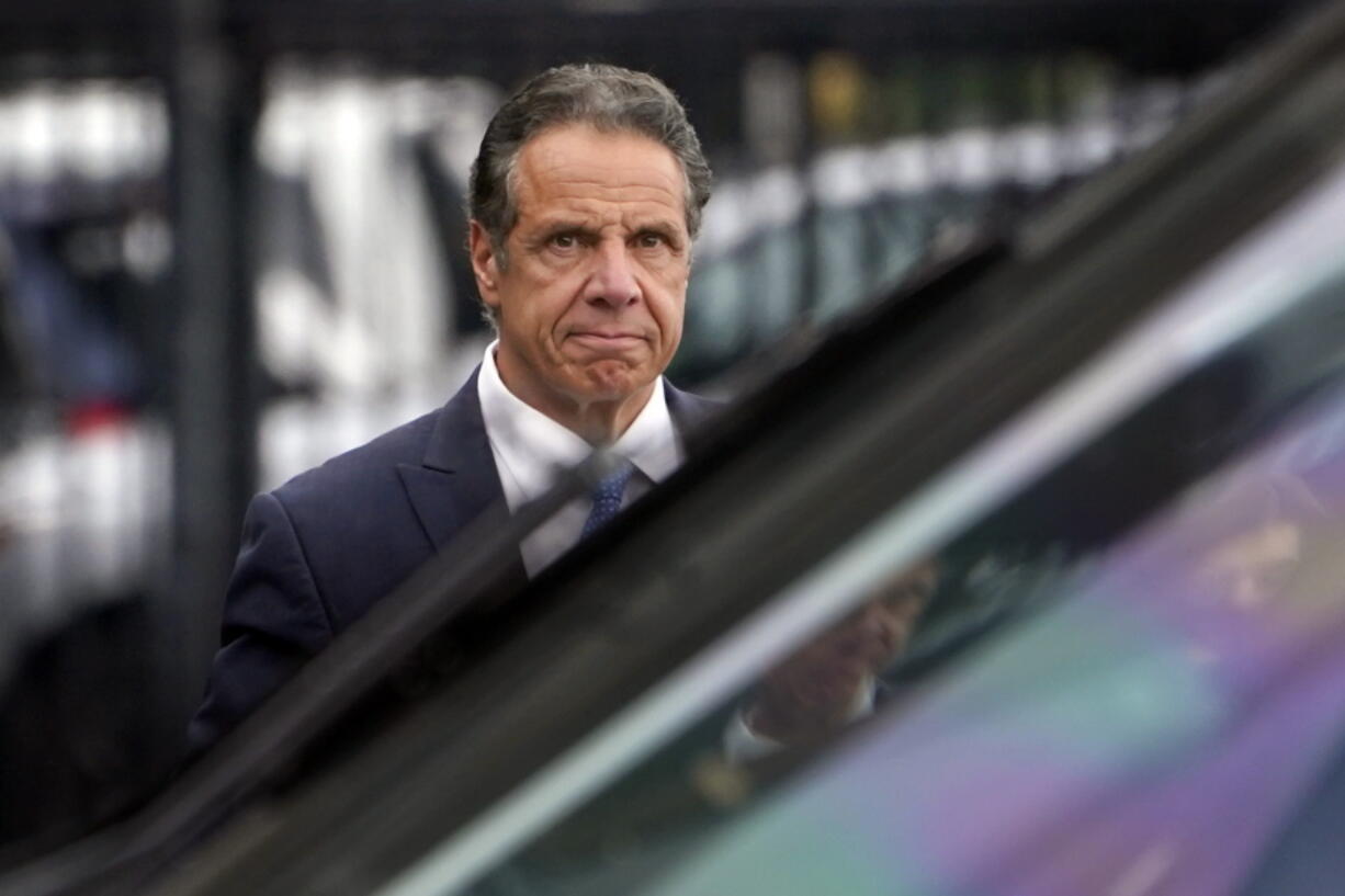 FILE - In this Tuesday, Aug. 10, 2021 file photo file photo, New York Gov. Andrew Cuomo prepares to board a helicopter after announcing his resignation in New York. Sexual harassment allegations cost Cuomo his job. Now, many want to see him answer for a scandal that cut to the heart of his reputation as a pandemic hero and had life-and-death consequences -- his handling of outbreaks in nursing homes.