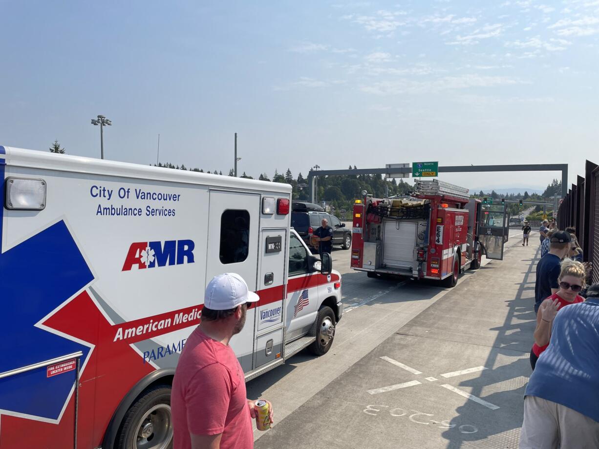 A Fire District 6 truck and an ambulance arrive on the 139th Street overpass on Interstate 5 before the procession for slain Clark County Sheriff's Det. Jeremy Brown.