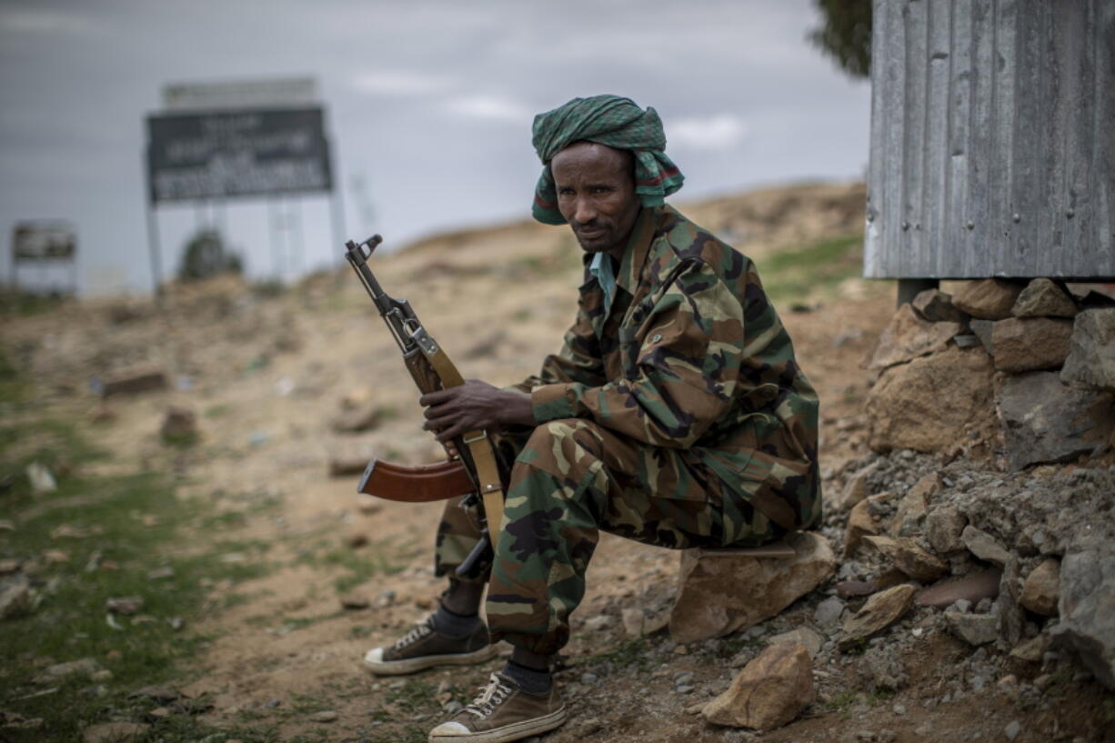 FILE - In this Friday, May 7, 2021 file photo, a fighter loyal to the Tigray People's Liberation Front (TPLF) mans a guard post on the outskirts of the town of Hawzen, then-controlled by the group but later re-taken by government forces, in the Tigray region of northern Ethiopia. Ethiopia's spreading Tigray conflict faces a fresh wave of fighting as an Amhara regional official says Amhara forces will launch an offensive on Saturday, Aug. 7, 2021 against Tigray forces who have entered the region and taken control of a town hosting a UNESCO World Heritage Site. The Amhara region's head of peace and security says "this is the time for the Amhara people to crush the terrorist group." Separately, Ethiopia's foreign ministry warns that the Tigray forces' incursion into the Amhara and Afar regions in recent weeks "is testing the federal government's patience" on the unilateral cease-fire it declared weeks ago.