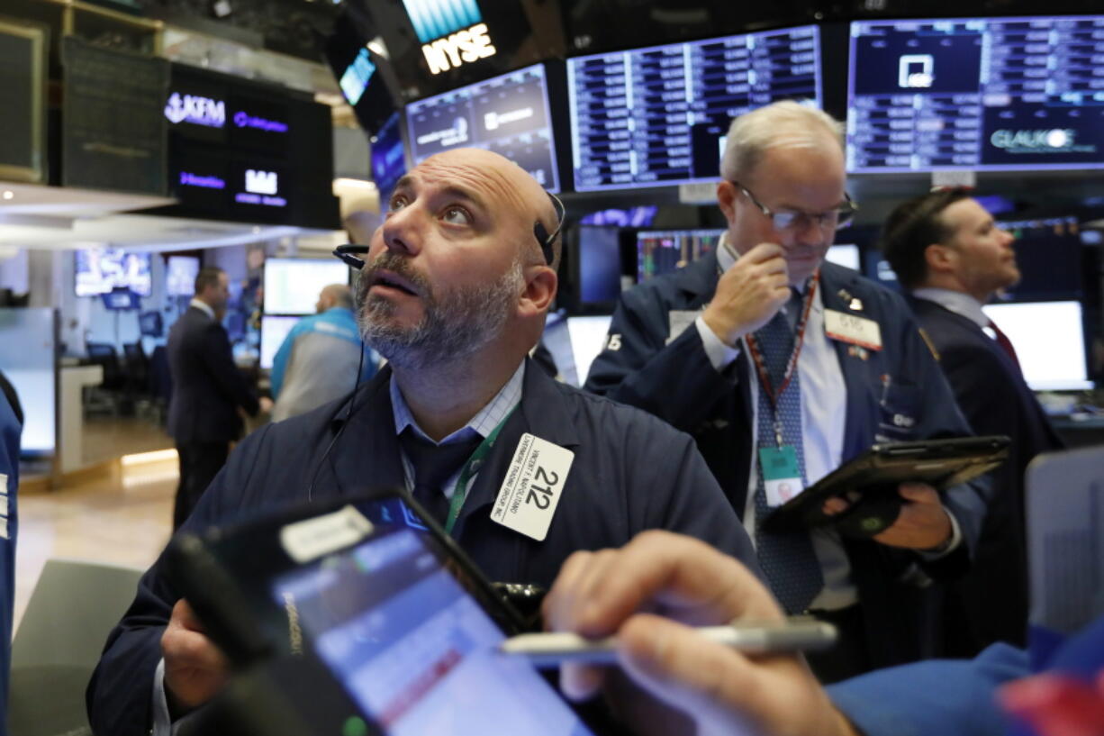 FILE - Trader Vincent Napolitano, left, works on the floor of the New York Stock Exchange, in this Friday, Nov. 9, 2018, file photo. Stocks are opening lower on Wall Street, with energy companies logging some of the biggest losses as oil prices take another turn lower. The S&P 500 index was off 0.2% in the first few minutes of trading Monday, Aug. 9, 2021, and the Nasdaq was down by a similar amount.