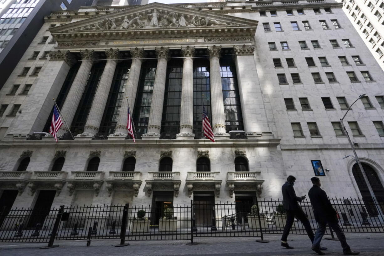 FILE - In this March 23, 2021 file photo, pedestrians walk past the New York Stock Exchange in New York's Financial District.  Stocks are starting August on a strong note after the S&P 500 closed out its sixth straight month of gains.