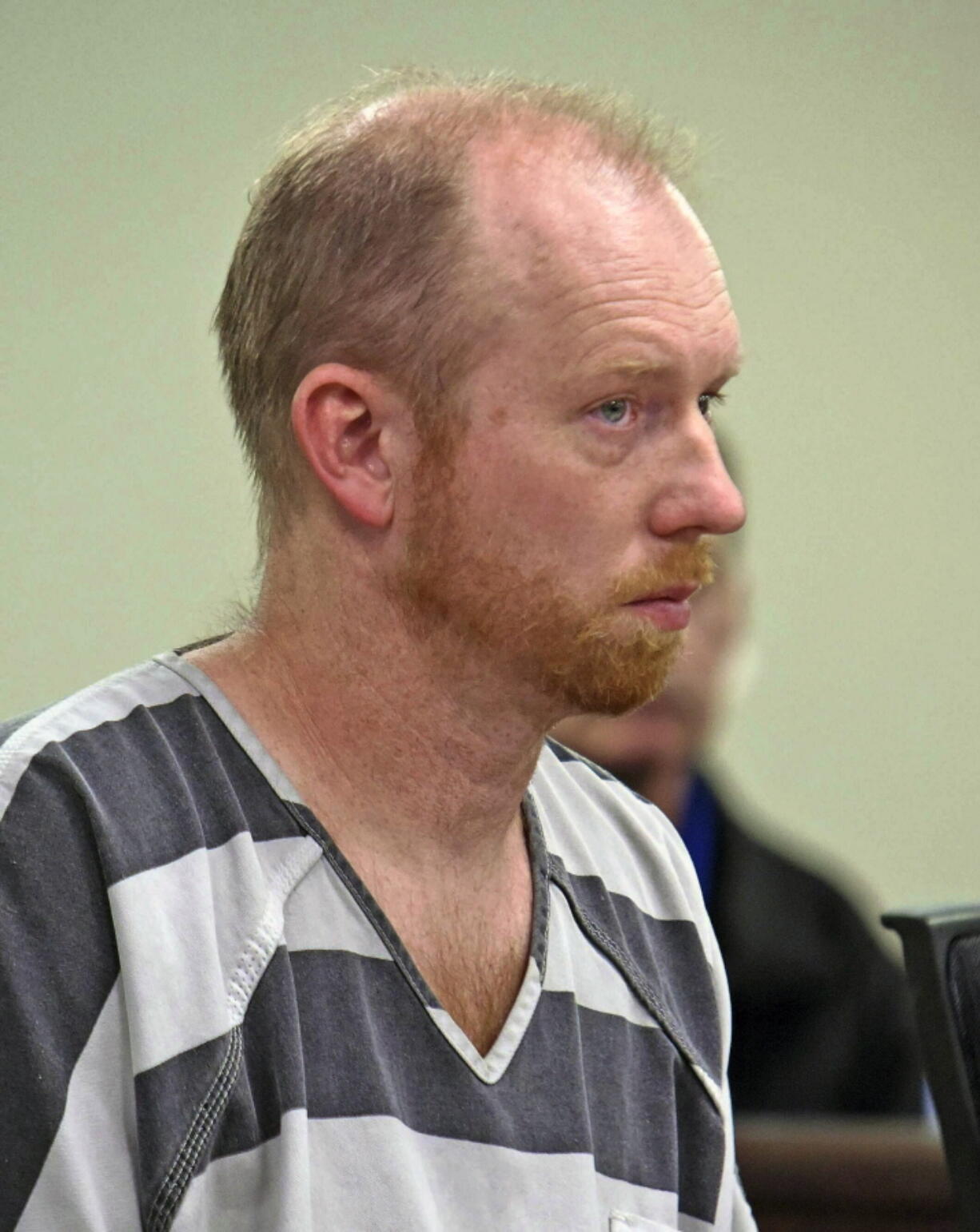 FILE - In this April 5, 2019, file photo, Chad Isaak listens while being charged with four counts of class AA felony murder in district court in Mandan, N.D. Isaak, accused of killing four people at a North Dakota property management compan, has waived a preliminary hearing and pleaded not guilty to murder charges. Isaak's trial is set to begin this week.