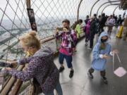 FILE - In this Friday, July 16, 2021 file photo, visitors enjoy the view from top of the Eiffel Tower in Paris. The European Union is expected to recommend that its member states reinstate restrictions on tourists from the U.S. because of rising coronavirus infection levels in the country, EU diplomats said Monday, Aug. 30.