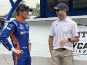 Scott Dixon, left, chats with Chip Ganassi Racing teammate Jimmie Johnson before the start of practice Friday in Nashville, Tenn.