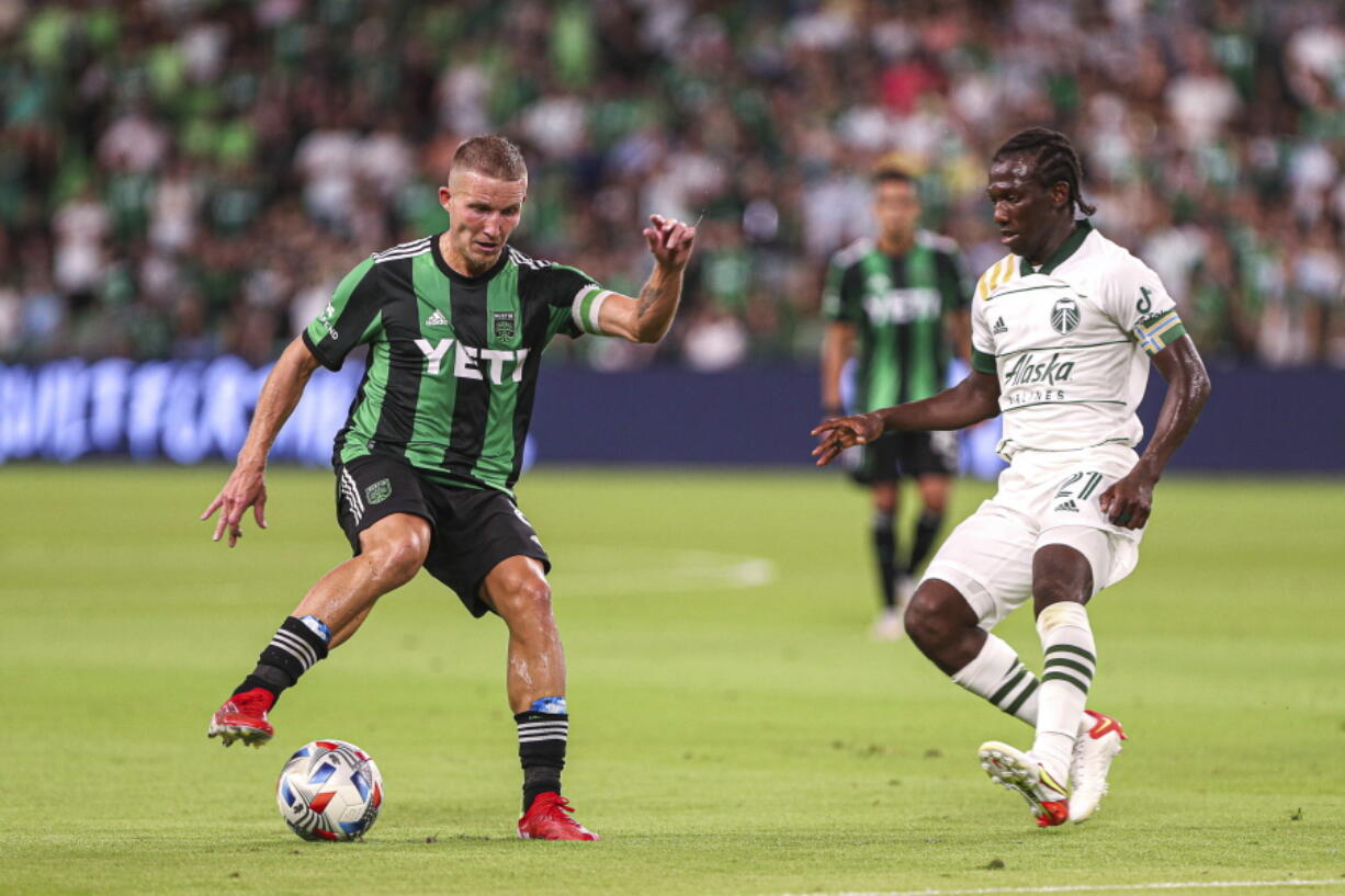 Austin FC midfielder Alex Ring protects the ball from Portland Timbers forward Dairon Asprilla during an MLS soccer match Saturday, Aug. 21, 2021, in Austin, Texas. (Aaron E.