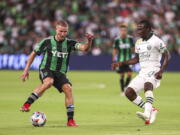 Austin FC midfielder Alex Ring protects the ball from Portland Timbers forward Dairon Asprilla during an MLS soccer match Saturday, Aug. 21, 2021, in Austin, Texas. (Aaron E.