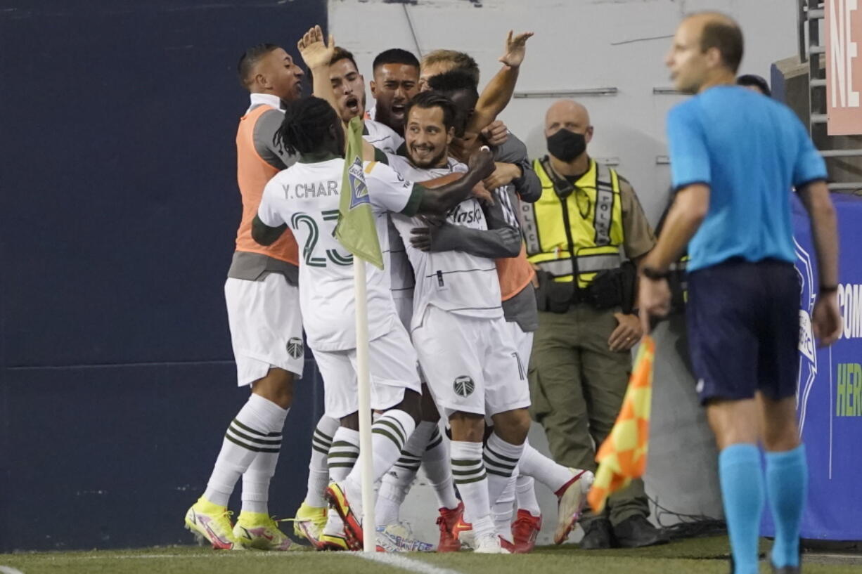 Portland Timbers midfielder Sebastian Blanco, center, celebrates with teammates after he scored a goal against the Seattle Sounders during the second half of an MLS soccer match, Sunday, Aug. 29, 2021, in Seattle. (AP Photo/Ted S.