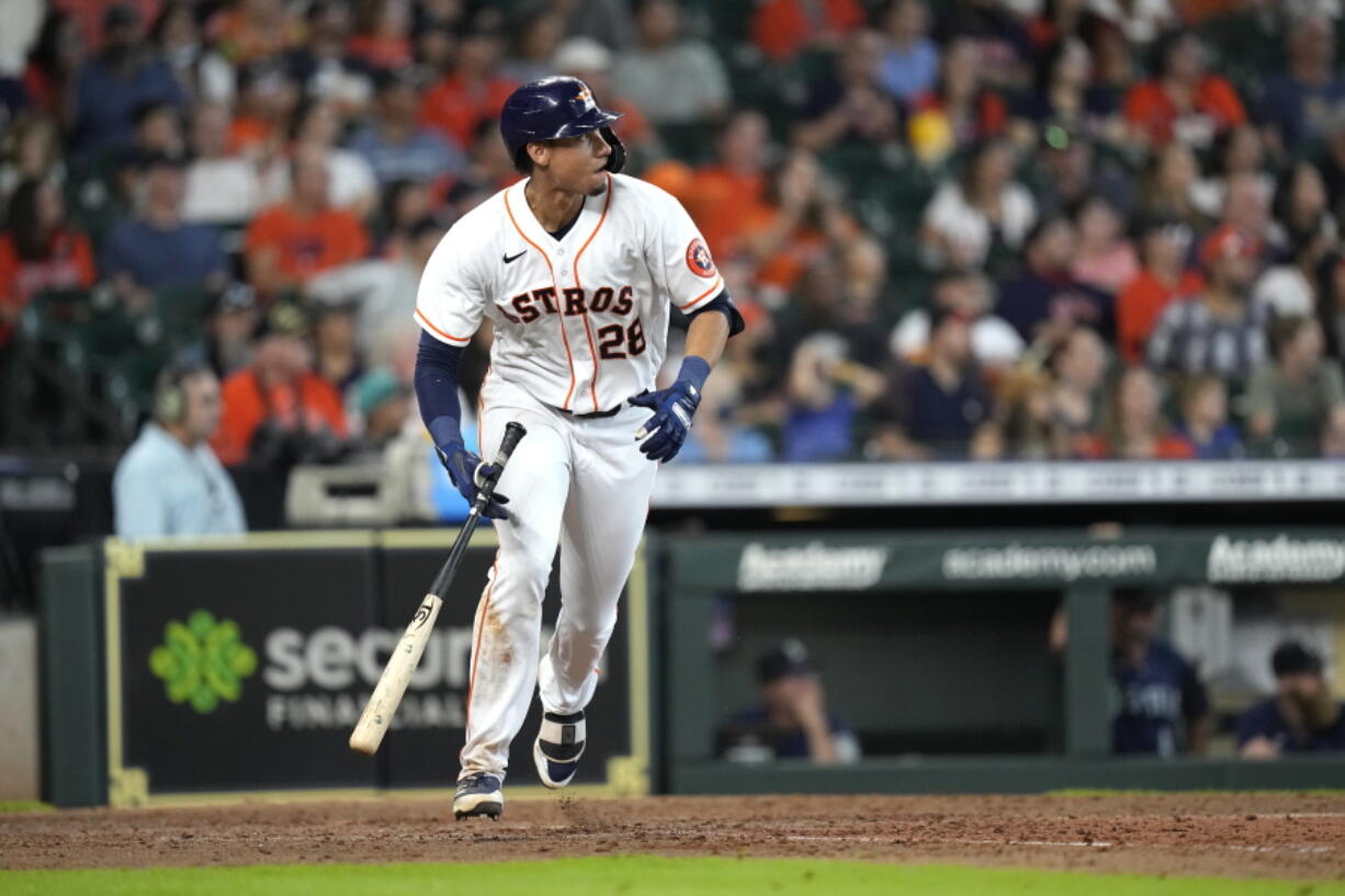 Houston Astros' Taylor Jones watches his two-run triple against the Seattle Mariners during the sixth inning of a baseball game Saturday, Aug. 21, 2021, in Houston. (AP Photo/David J.