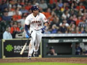 Houston Astros' Taylor Jones watches his two-run triple against the Seattle Mariners during the sixth inning of a baseball game Saturday, Aug. 21, 2021, in Houston. (AP Photo/David J.