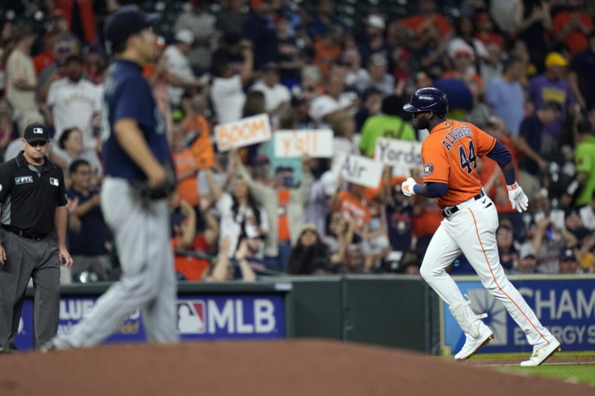 Houston Astros' Yordan Alvarez (44) runs the bases after hitting a two-run home run off Seattle Mariners starting pitcher Yusei Kikuchi, left, during the third inning of a baseball game Friday, Aug. 20, 2021, in Houston. (AP Photo/David J.